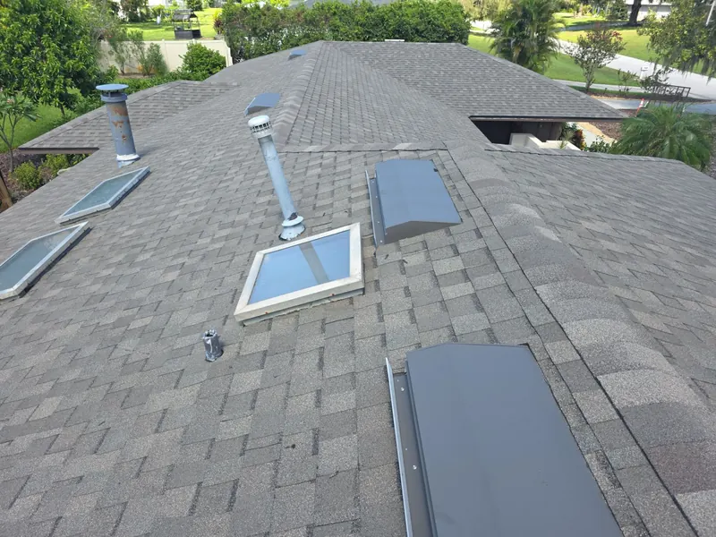 Asphalt shingle roof on a Lakeland home with skylights, vent pipes and box vents